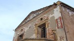 Detail of the facade of Miguel Nolla's house , the Palauet, with his tiled portrait overlooking the factory.